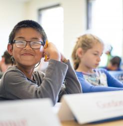 A student smiles at the camera.