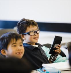 Several students smile, and one holds a calculator.